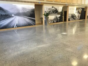 a hall with marble floor and posters