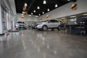 a car showroom with two white cars
