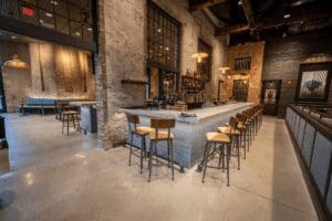 a bar counter with stools places in a line